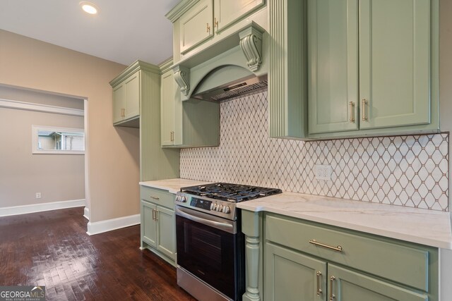 409 N Jefferson Ave, Eatonton, GA 31024 - kitchen featuring gas range, green cabinetry, under cabinet range hood, dark wood-style flooring, and backsplash