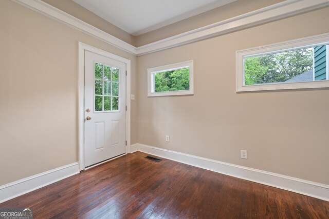 409 N Jefferson Ave, Eatonton, GA 31024 - doorway to outside featuring dark wood-style flooring and baseboards