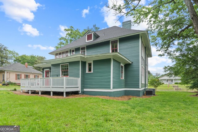 409 N Jefferson Ave, Eatonton, GA 31024 - back of house with a chimney, central air condition unit, a yard, and a shingled roof