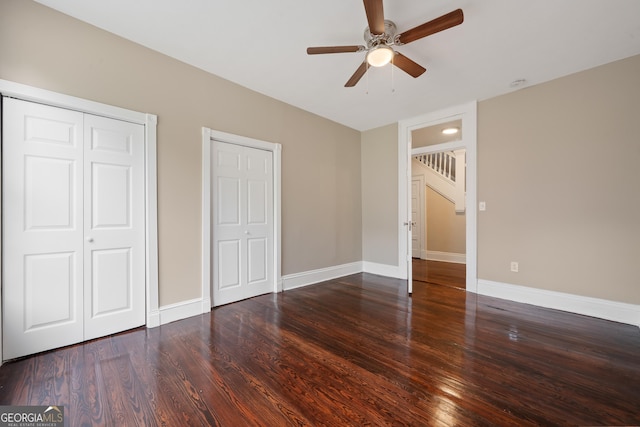 409 N Jefferson Ave, Eatonton, GA 31024 - unfurnished bedroom with wood finished floors, baseboards, and a ceiling fan