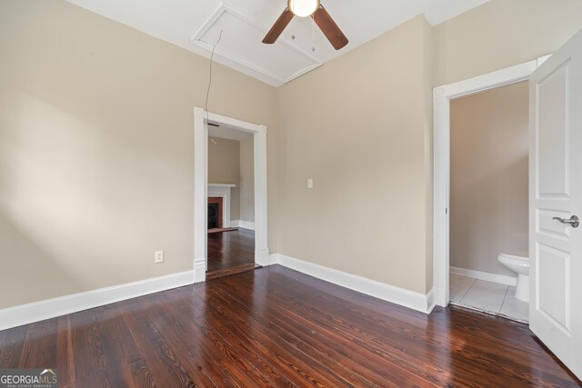 409 N Jefferson Ave, Eatonton, GA 31024 - unfurnished bedroom featuring attic access, wood finished floors, baseboards, a fireplace, and ceiling fan