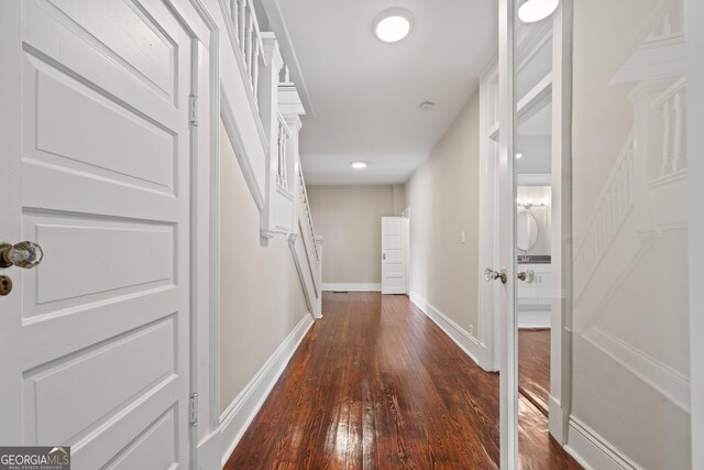 409 N Jefferson Ave, Eatonton, GA 31024 - hall with dark wood-type flooring and baseboards