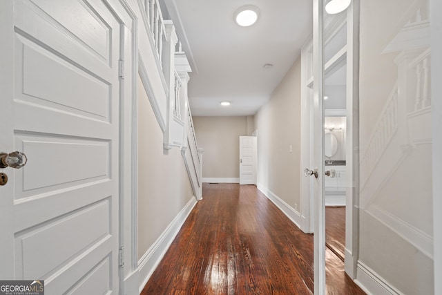 409 N Jefferson Ave, Eatonton, GA 31024 - hall with dark wood-style floors and baseboards