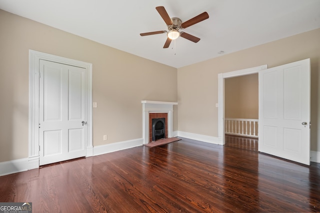 409 N Jefferson Ave, Eatonton, GA 31024 - unfurnished living room with a ceiling fan, wood finished floors, a fireplace, and baseboards