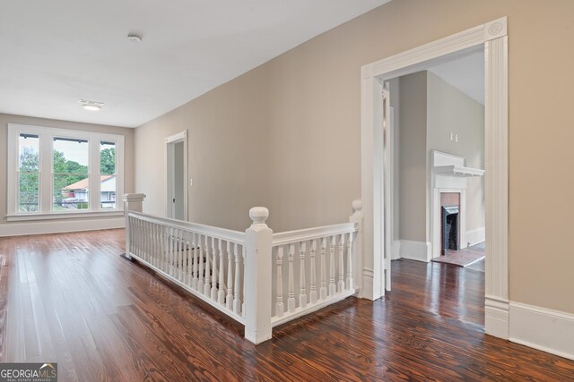409 N Jefferson Ave, Eatonton, GA 31024 - hall featuring an upstairs landing, wood finished floors, and baseboards