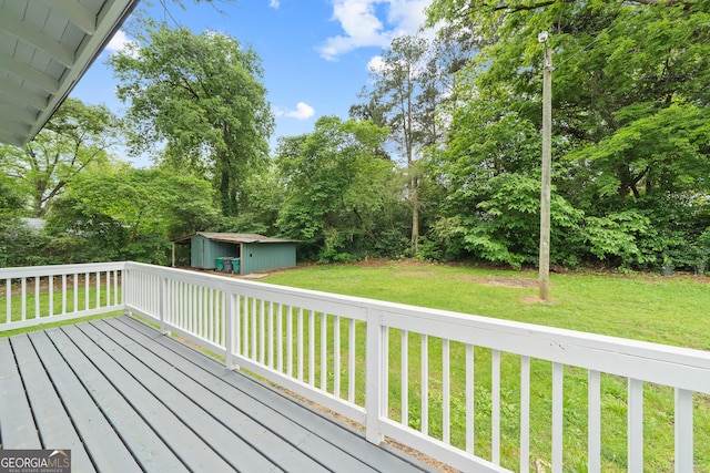 409 N Jefferson Ave, Eatonton, GA 31024 - wooden deck with a shed, a lawn, and view of scattered trees