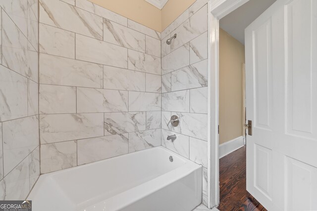 409 N Jefferson Ave, Eatonton, GA 31024 - bathroom with shower / bathtub combination and wood finished floors