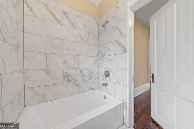 409 N Jefferson Ave, Eatonton, GA 31024 - bathroom with shower / tub combination and wood finished floors
