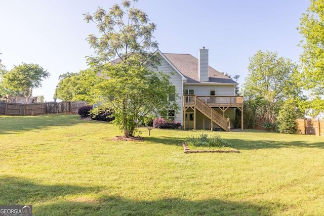 rear view of house with stairway, a deck, and a chimney