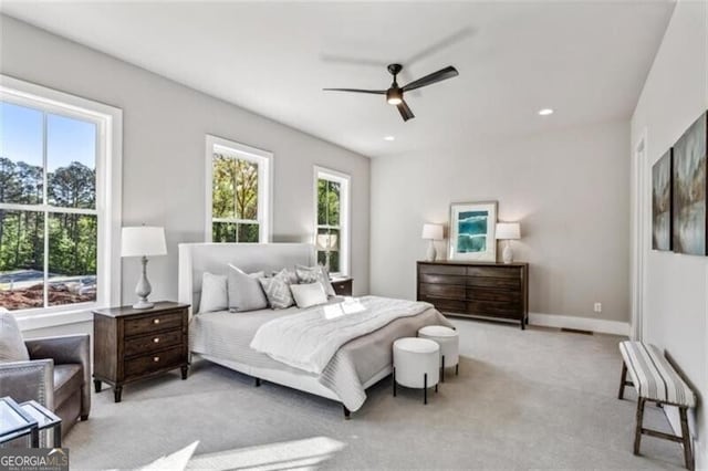 bedroom with light colored carpet, a ceiling fan, recessed lighting, and baseboards
