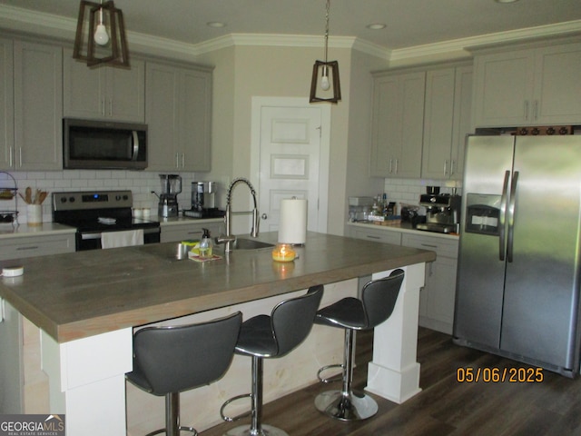 183 Piedmont Lake Dr Unit 152, Gray, GA 31032 - kitchen with appliances with stainless steel finishes, tasteful backsplash, a sink, dark wood finished floors, and a center island with sink