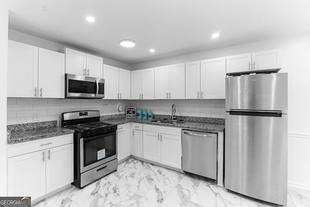 118 Greentree Pkwy, Macon, GA 31220 - kitchen with appliances with stainless steel finishes, light marble finish flooring, white cabinets, recessed lighting, and dark stone countertops