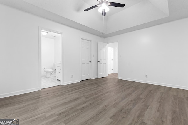118 Greentree Pkwy, Macon, GA 31220 - unfurnished bedroom featuring wood finished floors, baseboards, ensuite bathroom, and a ceiling fan
