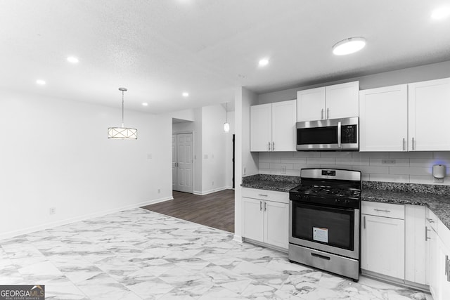 118 Greentree Pkwy, Macon, GA 31220 - kitchen featuring stainless steel appliances, recessed lighting, tasteful backsplash, white cabinets, and light marble finish flooring