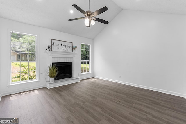 118 Greentree Pkwy, Macon, GA 31220 - unfurnished living room with dark wood-type flooring, a ceiling fan, high vaulted ceiling, and a tile fireplace