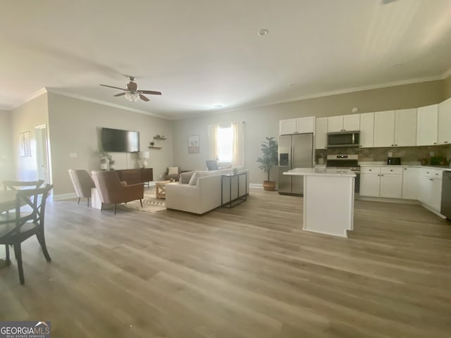 3812 Hartley Bridge Rd, Macon, GA 31216 - living room featuring baseboards, crown molding, light wood-style floors, and ceiling fan