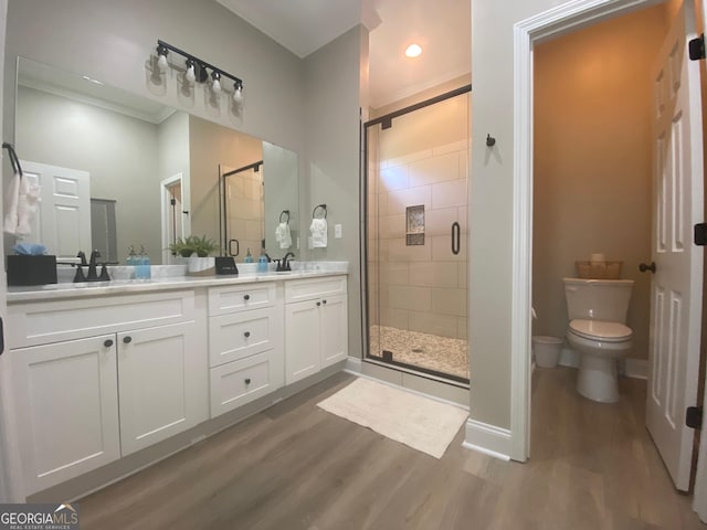 3812 Hartley Bridge Rd, Macon, GA 31216 - full bath with wood finished floors, a shower stall, toilet, and double vanity