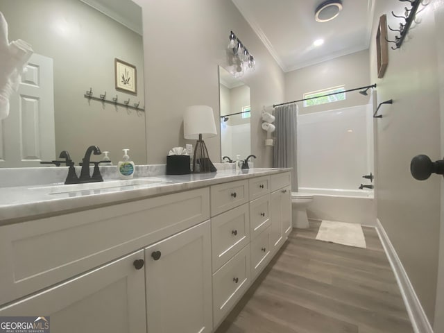 3812 Hartley Bridge Rd, Macon, GA 31216 - full bath featuring ornamental molding, wood finished floors, shower / tub combo, double vanity, and toilet