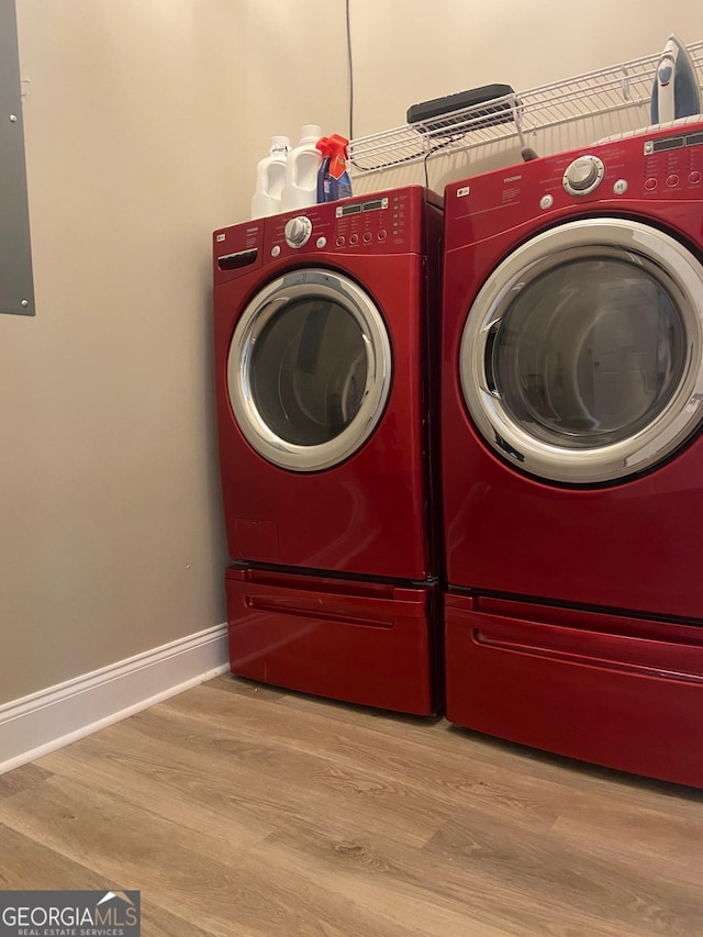 3812 Hartley Bridge Rd, Macon, GA 31216 - laundry room with washing machine and clothes dryer, wood finished floors, and baseboards