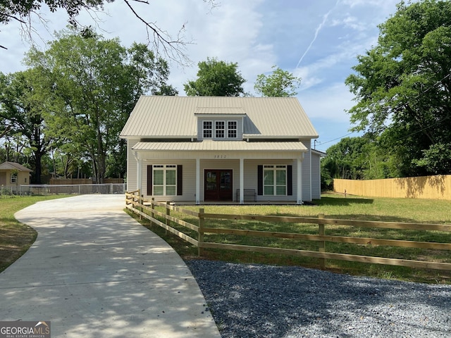 3812 Hartley Bridge Rd, Macon, GA 31216 - view of front of house featuring a porch, concrete driveway, french doors, and metal roof