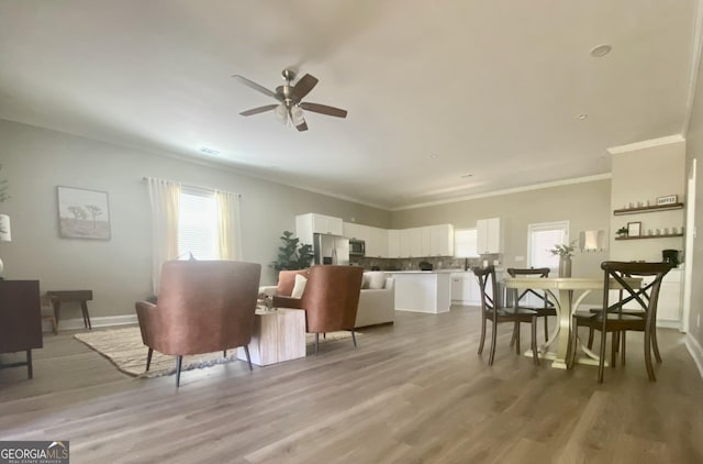 3812 Hartley Bridge Rd, Macon, GA 31216 - living area featuring a ceiling fan, plenty of natural light, ornamental molding, and light wood-type flooring