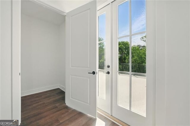 doorway to outside with dark wood-type flooring and baseboards