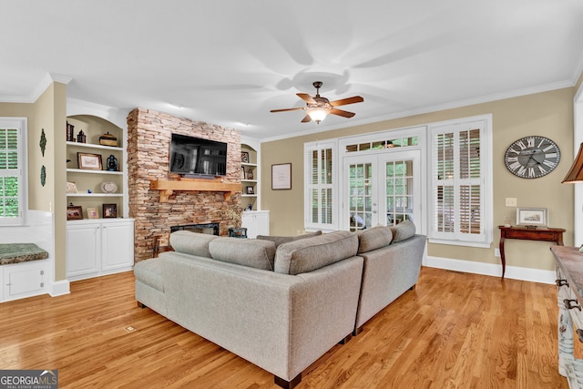 1477 Edenham Ln, Cumming, GA 30041 - living area with light wood-style floors, crown molding, a ceiling fan, a fireplace, and built in features