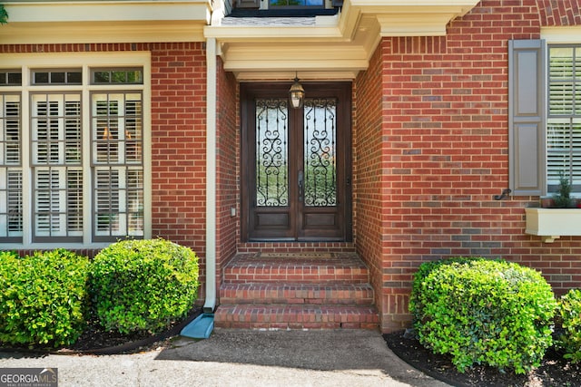 view of exterior entry with brick siding