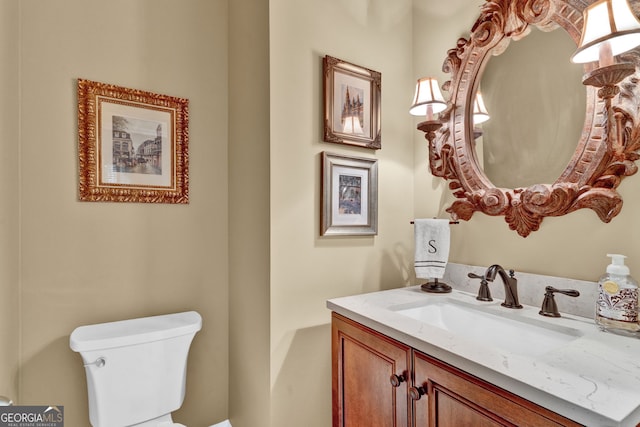 half bath featuring toilet and vanity