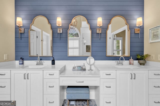 bathroom featuring vanity and wood walls