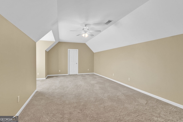 additional living space with carpet floors, ceiling fan, lofted ceiling, and baseboards