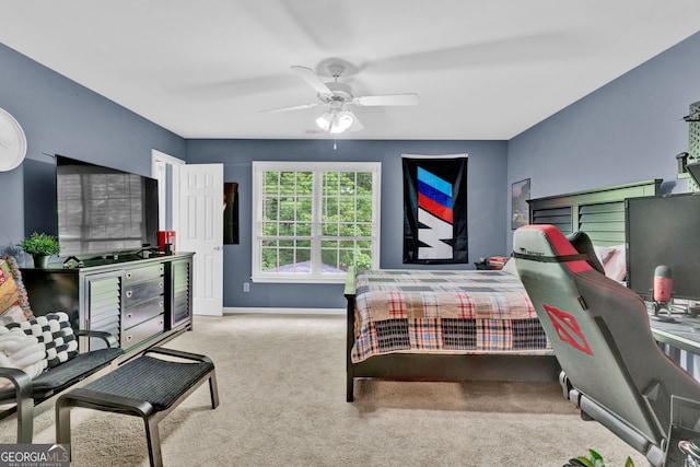 carpeted bedroom with baseboards and ceiling fan