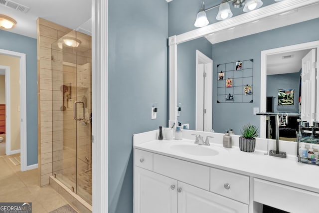 bathroom featuring a stall shower, tile patterned flooring, and vanity