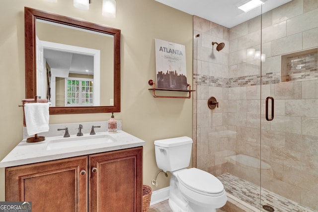 full bathroom with a stall shower, toilet, and vanity