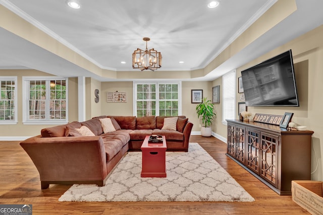 living room with a chandelier, crown molding, recessed lighting, baseboards, and wood finished floors