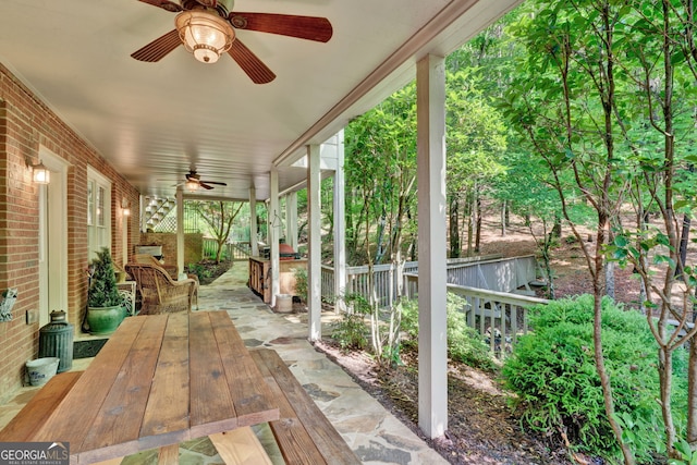 sunroom / solarium featuring ceiling fan