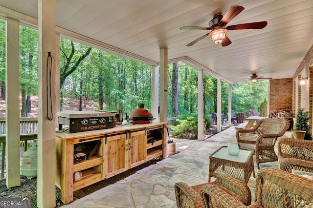 view of patio / terrace with ceiling fan and exterior kitchen