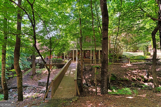 view of jungle gym with fence and a wooden deck