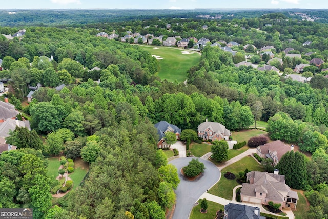 aerial perspective of suburban area featuring a golf club and a forest