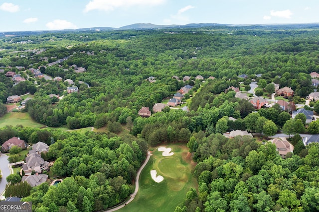 aerial view of residential area with a heavily wooded area and a golf club