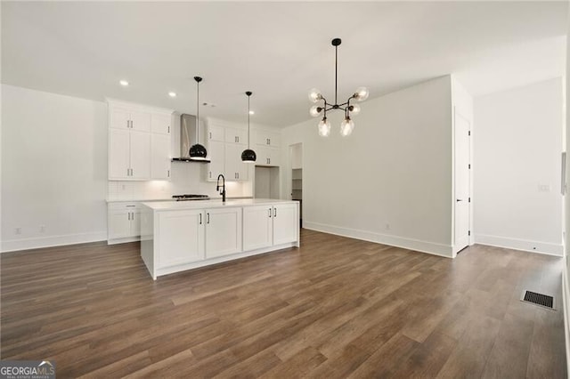 2150 Tidwell Ln Unit 5, Atlanta, GA 30318 - kitchen featuring wall chimney exhaust hood, white cabinetry, an island with sink, dark wood finished floors, and recessed lighting