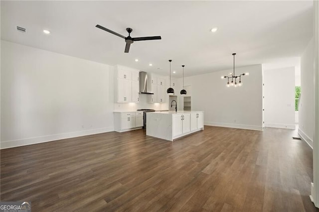 2150 Tidwell Ln Unit 5, Atlanta, GA 30318 - kitchen featuring open floor plan, wall chimney range hood, a chandelier, a ceiling fan, and dark wood-type flooring
