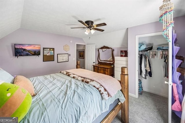 carpeted bedroom featuring a closet, a ceiling fan, vaulted ceiling, and baseboards