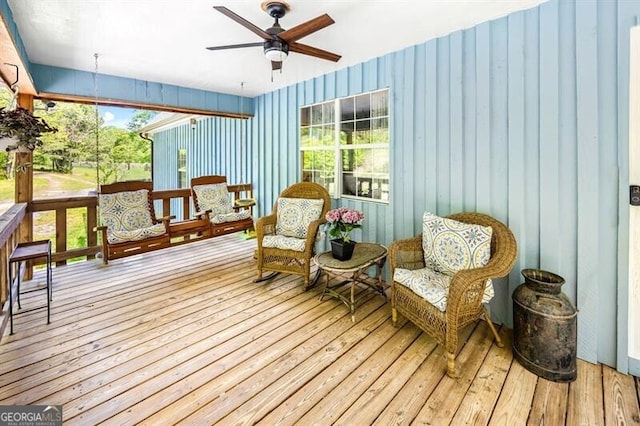 sunroom / solarium with a ceiling fan