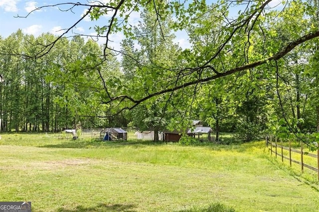 view of yard with a view of trees