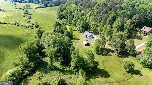 aerial view of property's location with a heavily wooded area