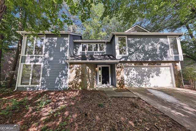 5362 Kelleys Mill Cir, Stone Mountain, GA 30088 - view of front facade with an attached garage, stone siding, and driveway
