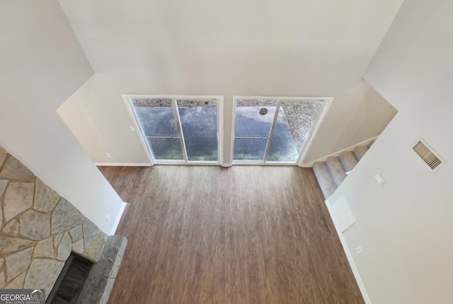 5362 Kelleys Mill Cir, Stone Mountain, GA 30088 - unfurnished living room featuring wood finished floors, stairway, and plenty of natural light