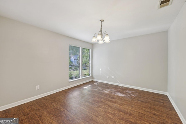 5362 Kelleys Mill Cir, Stone Mountain, GA 30088 - spare room with a chandelier, baseboards, and dark wood-type flooring