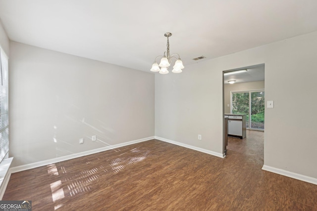 5362 Kelleys Mill Cir, Stone Mountain, GA 30088 - empty room with wood finished floors, a chandelier, and baseboards